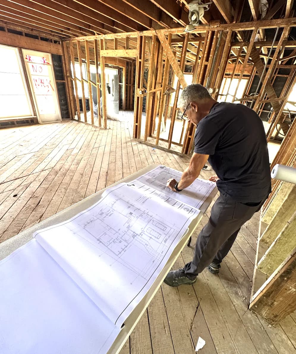 Liam and his dad reviewing construction plans at a Beverly Hills remodel by Forma Homes