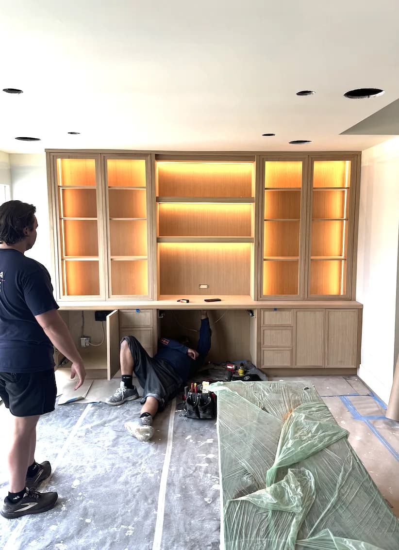 Shawn, owner of Forma Homes, reviewing custom cabinetry lighting at a Playa del Rey build